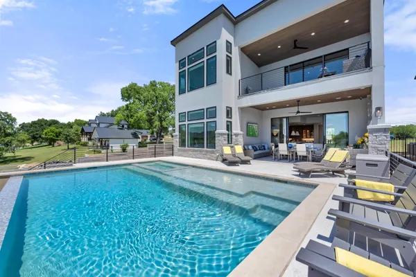 a swimming pool view with a outdoor seating space