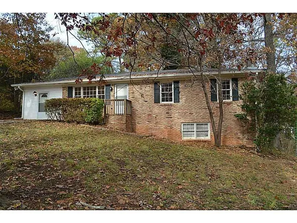 a view of a yard in front of a house with large trees