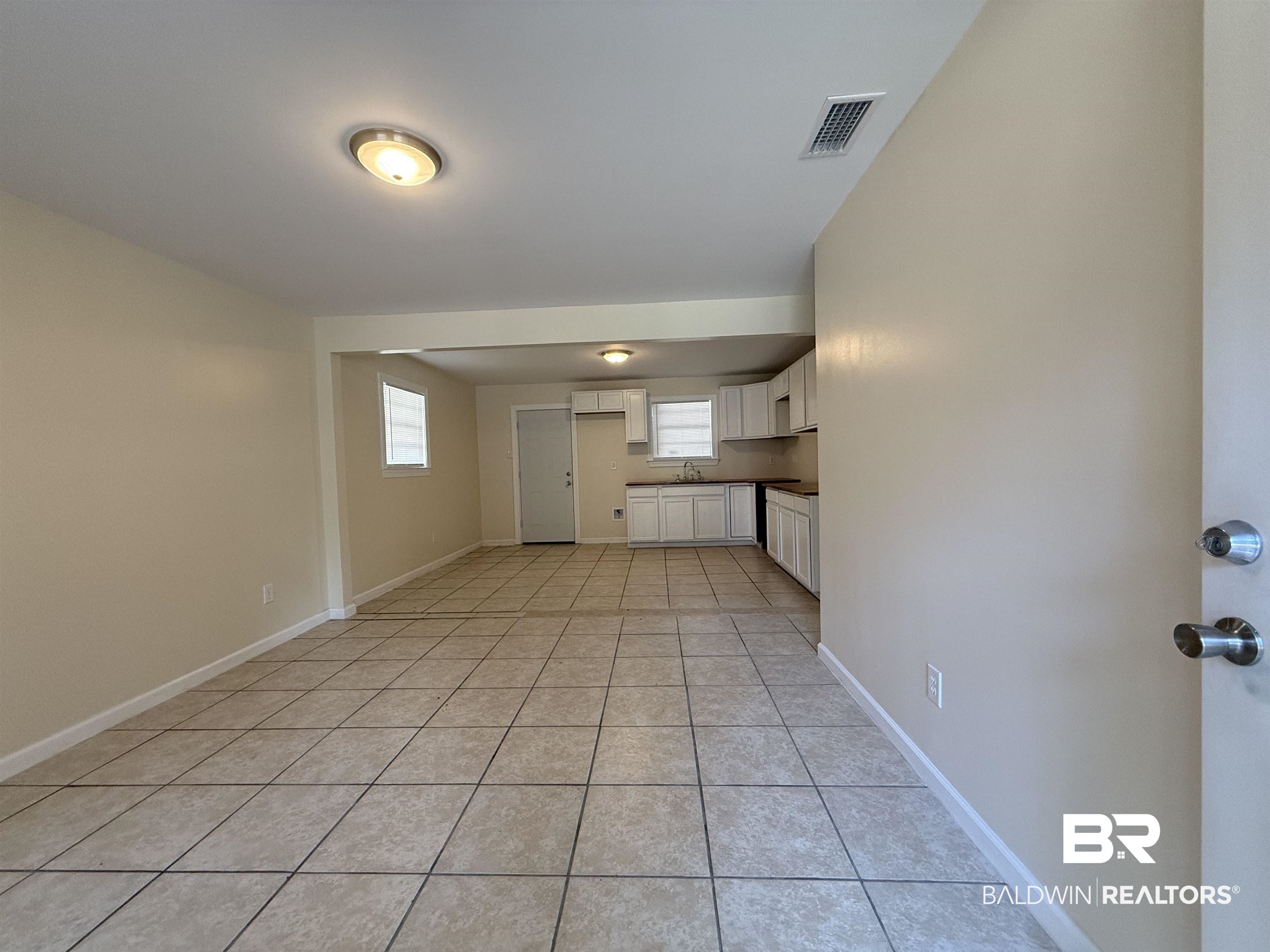 320 E Street Prichard, AL 36610 - Photo 2 of 16 Unfurnished living room featuring sink and light tile patterned floors