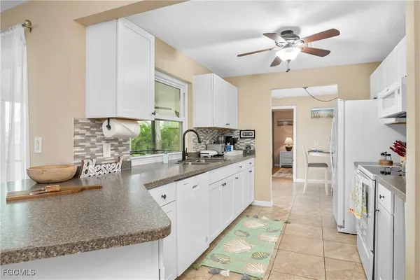 a kitchen with stainless steel appliances granite countertop a sink and a stove