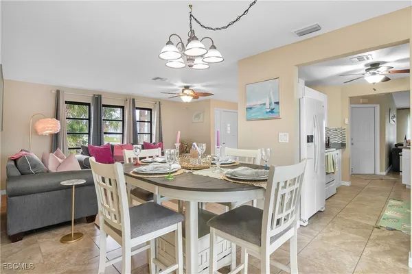 a view of a dining room with furniture and chandelier
