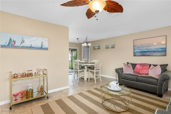 a living room with furniture and a dining area
