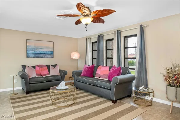 a living room with furniture and a potted plant