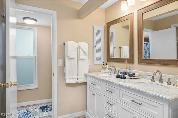 a bathroom with a double vanity sink and a mirror