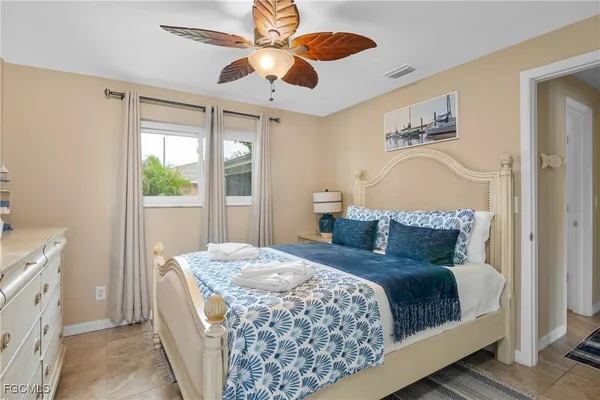 a bedroom with a large bed and a window