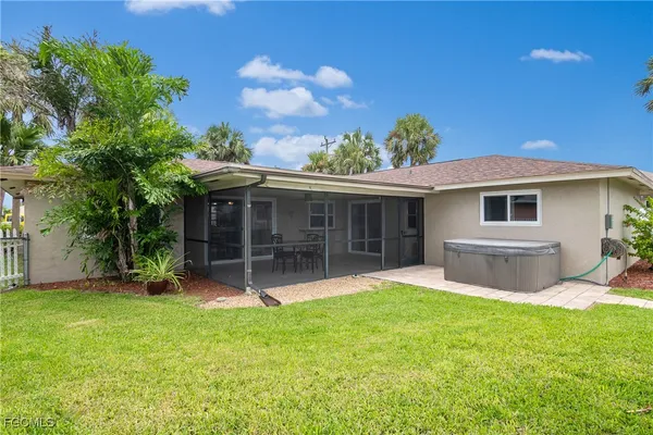 a view of a house with a yard and sitting area