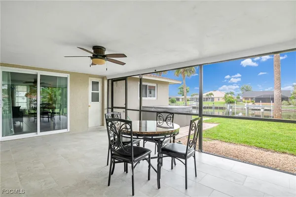 a view of a patio with a table and chairs