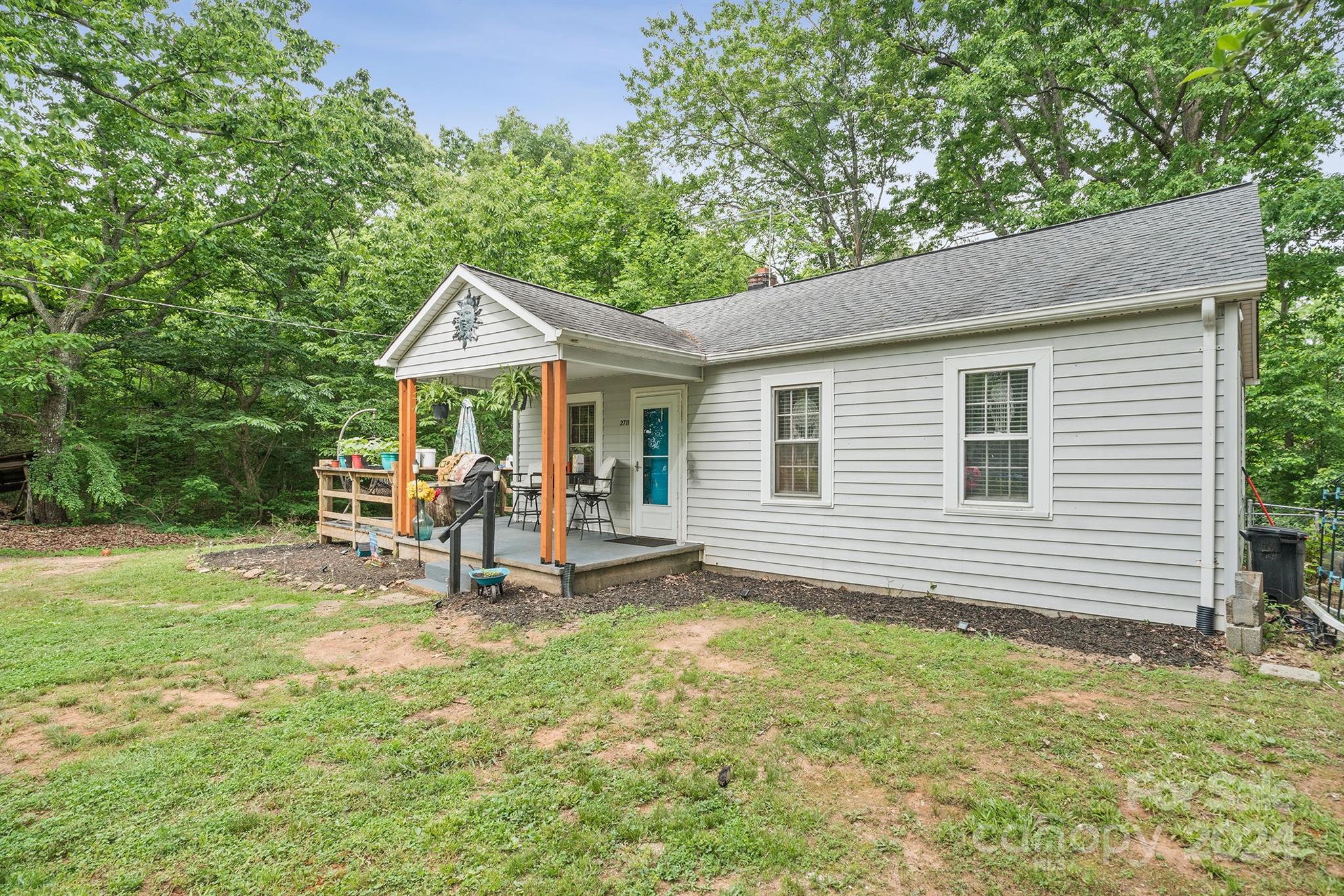 2711 Ellerwood Road Hudson, NC 28638 - Photo 2 of 19 a view of a chair and table in backyard of the house