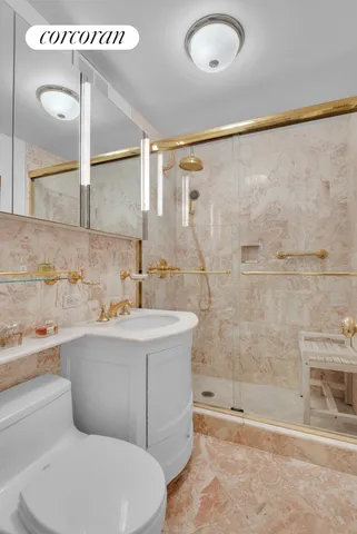 a bathroom with a sink mirror toilet and bathtub