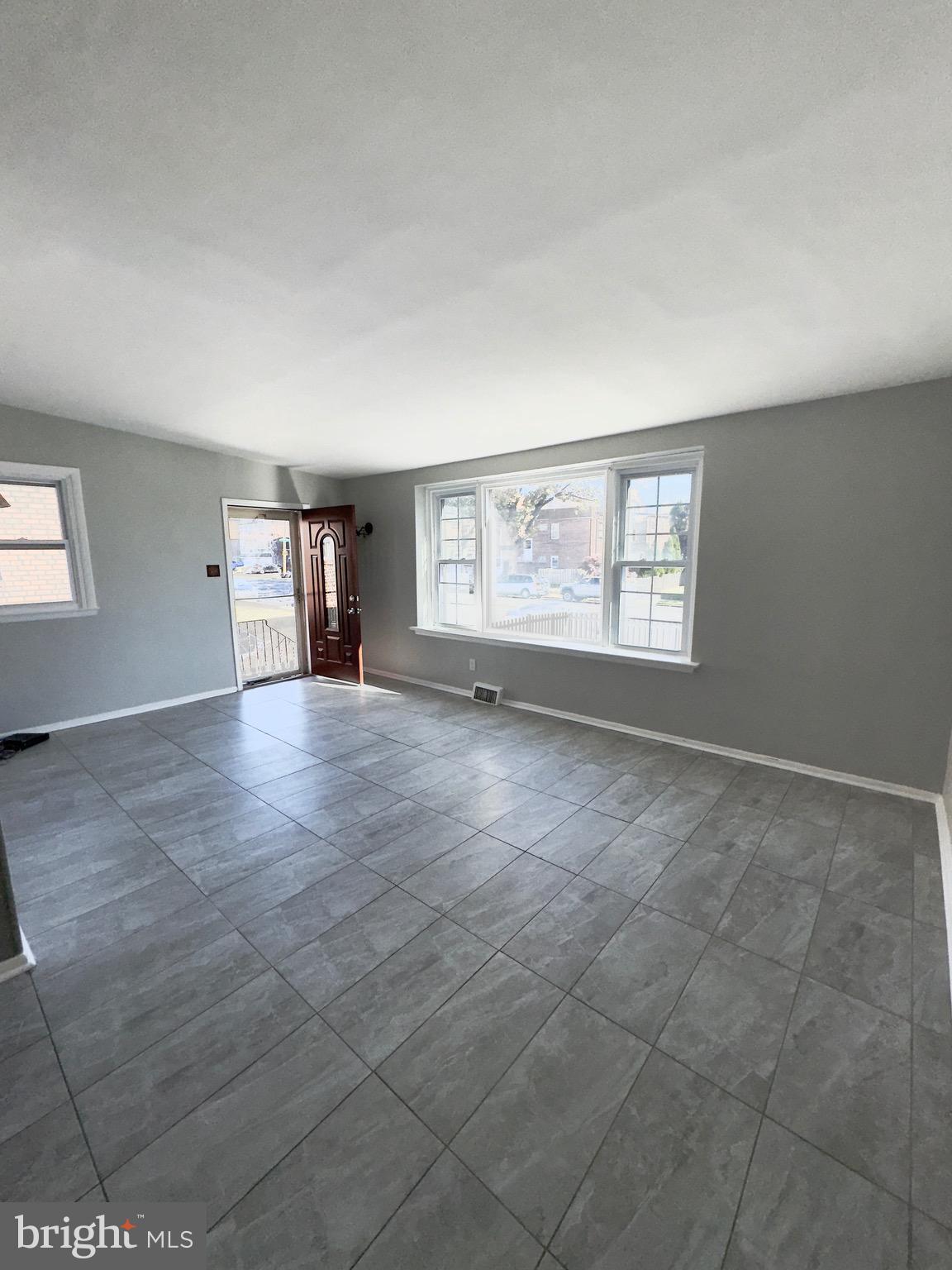 7806 Summerdale Avenue, Unit 1 Philadelphia, PA 19111 - Photo 2 of 9 wooden floor in an empty room with a window