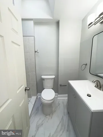 a white toilet sitting next to a bathroom sink