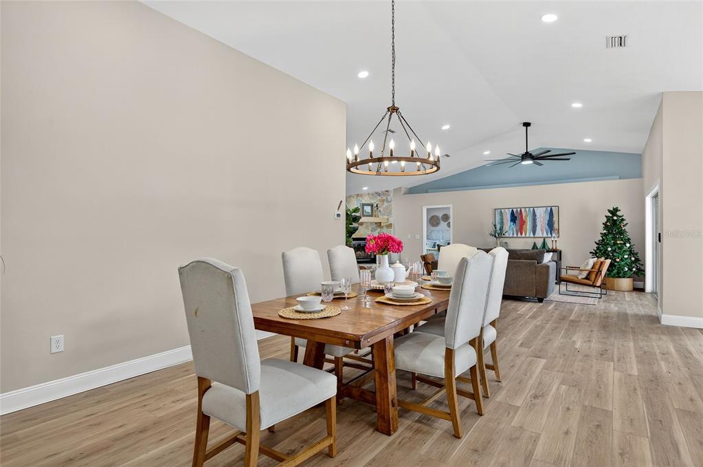 7078 South Threshold Point Homosassa, FL 34446 - Photo 11 of 75 a view of a dining room with furniture wooden floor and chandelier