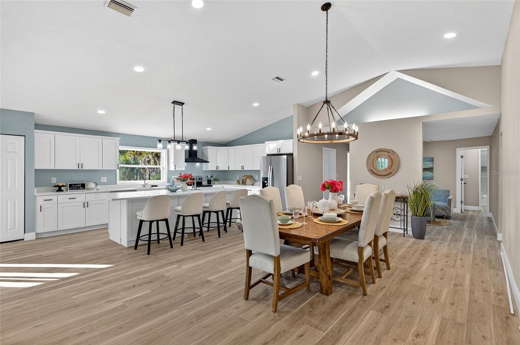 7078 South Threshold Point Homosassa, FL 34446 - Photo 12 of 75 a dining room filled chandelier and wooden floor