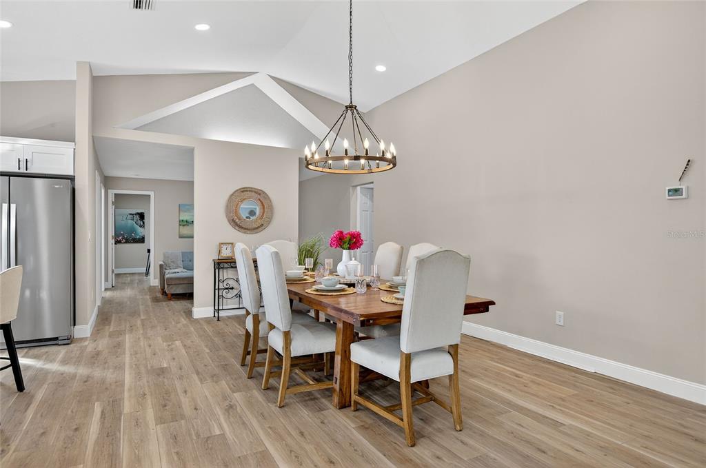7078 South Threshold Point Homosassa, FL 34446 - Photo 13 of 75 a dining room with furniture a chandelier and wooden floor