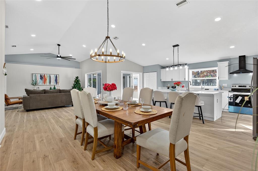 7078 South Threshold Point Homosassa, FL 34446 - Photo 16 of 75 a view of a dining room and livingroom with furniture wooden floor a chandelier