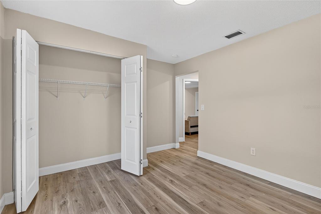 7078 South Threshold Point Homosassa, FL 34446 - Photo 23 of 75 a view of empty room with wooden floor