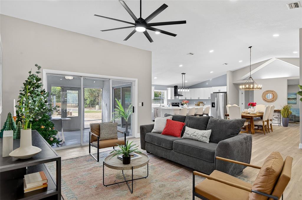 7078 South Threshold Point Homosassa, FL 34446 - Photo 36 of 75 a living room with furniture kitchen view and a potted plant