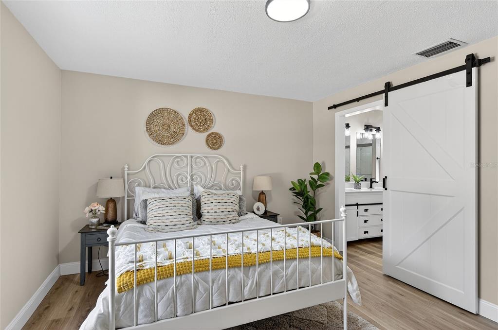 7078 South Threshold Point Homosassa, FL 34446 - Photo 38 of 75 a bedroom with a bed and a chandelier