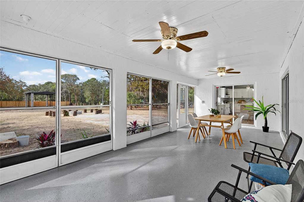 7078 South Threshold Point Homosassa, FL 34446 - Photo 55 of 75 a dining room with furniture a chandelier and a large window