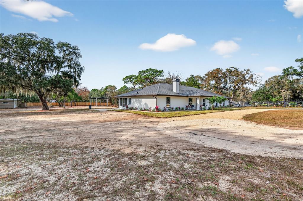 7078 South Threshold Point Homosassa, FL 34446 - Photo 60 of 75 a view of a swimming pool with an outdoor space and seating area