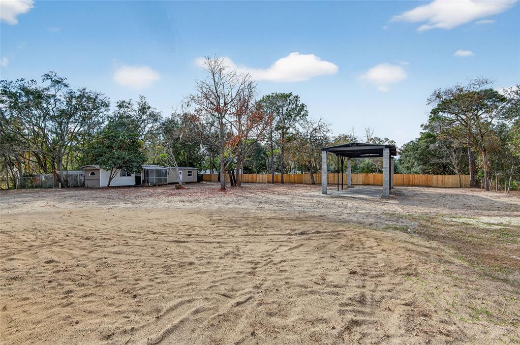 7078 South Threshold Point Homosassa, FL 34446 - Photo 63 of 75 a backyard of a house with lots of trees