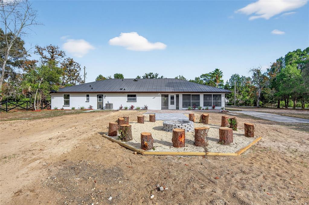7078 South Threshold Point Homosassa, FL 34446 - Photo 64 of 75 a front view of house with yard outdoor seating and covered with trees