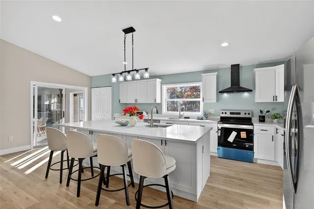 a dining room with furniture a chandelier and wooden floor