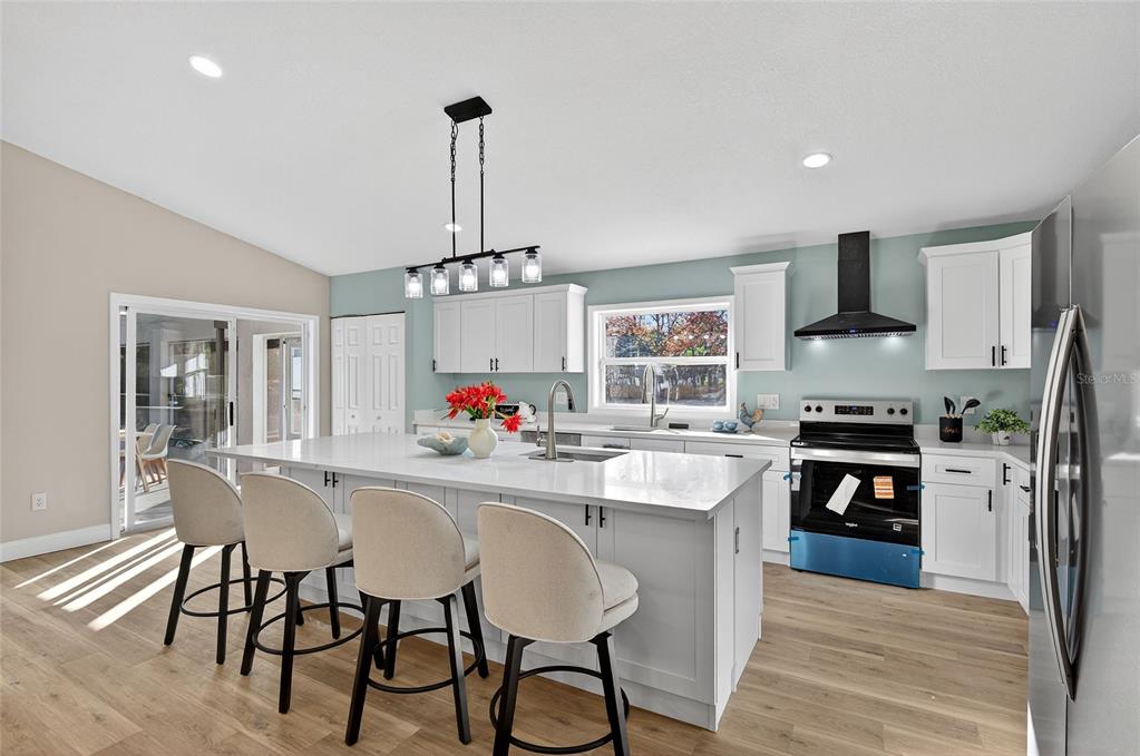 7078 South Threshold Point Homosassa, FL 34446 - Photo 8 of 75 a kitchen with a chandelier and stove