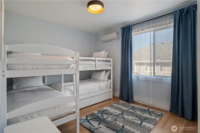 a bedroom with a bed and a painting on the wall