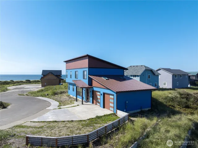 a view of a house with a yard and potted plants
