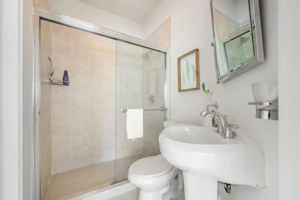 a bathroom with a sink toilet and shower