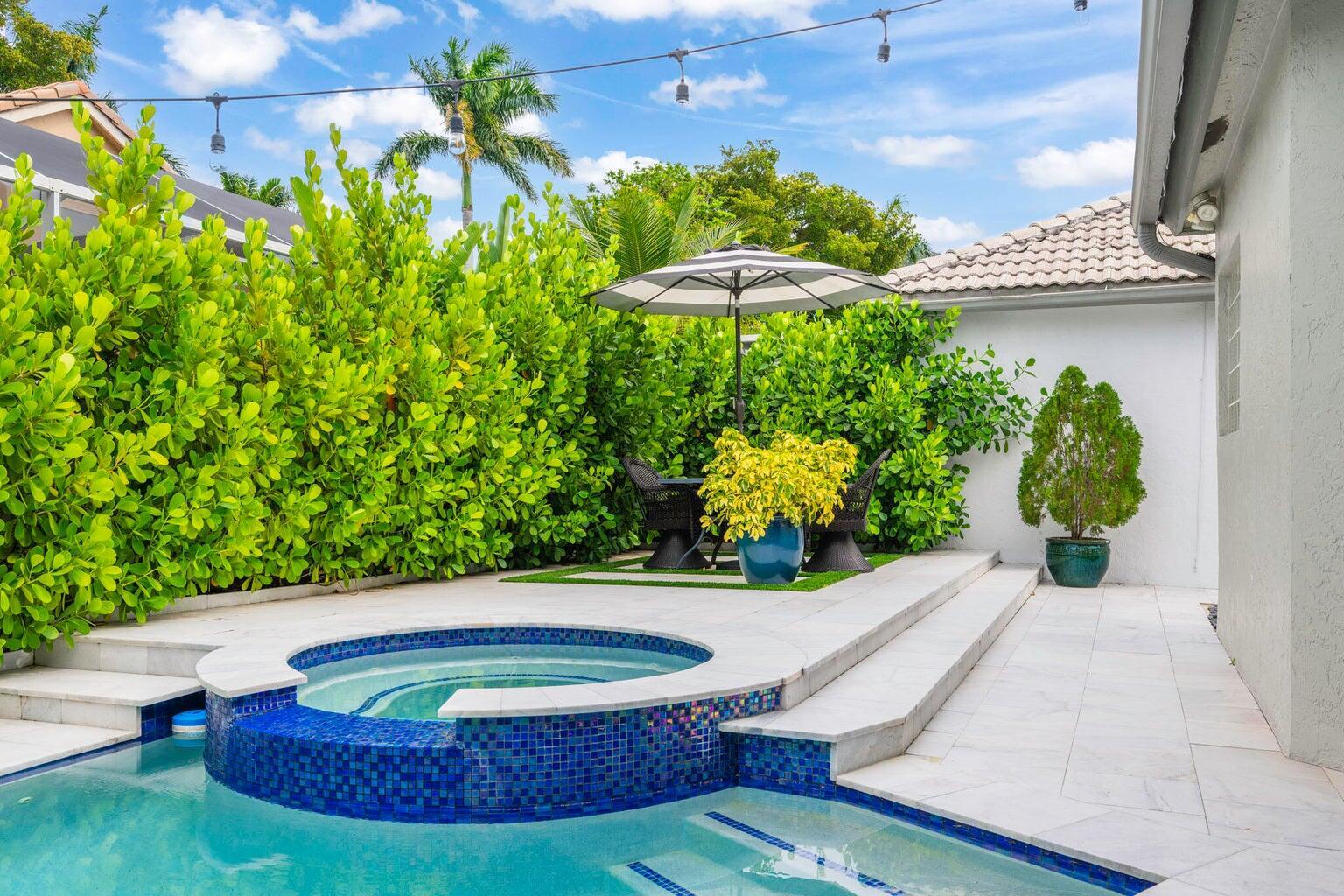 10982 Ravel Court Boca Raton, FL 33498 - Photo 27 of 43 a view of a swimming pool with a patio