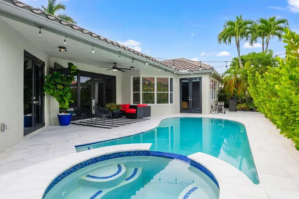 a swimming pool with outdoor seating and yard