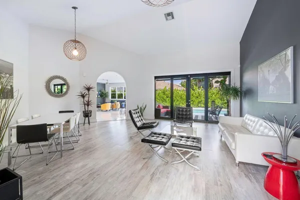 a living room with furniture a window and a chandelier