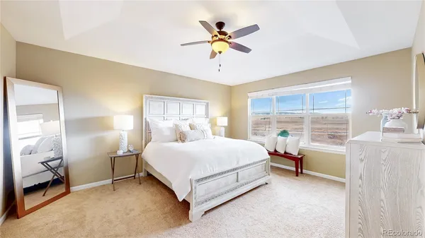 a spacious bedroom with a bed and a large window