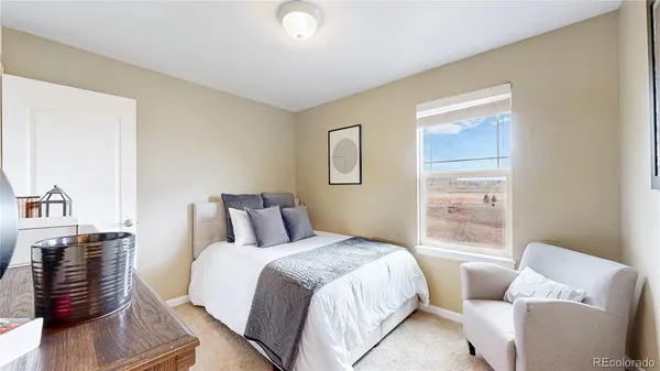 a bedroom with a bed and a couch