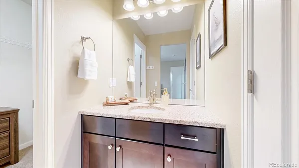 a bathroom with a sink vanity and mirror