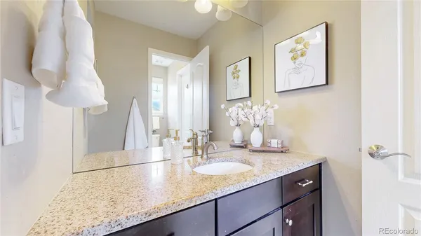 a bathroom with a granite countertop sink and a mirror