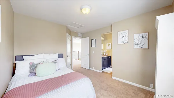 a bedroom with a bed and a lamp