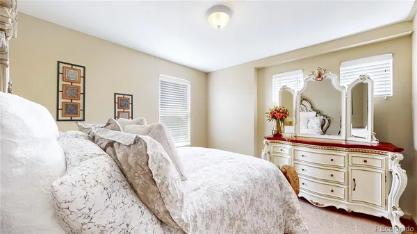 a bedroom with a bed and a dresser