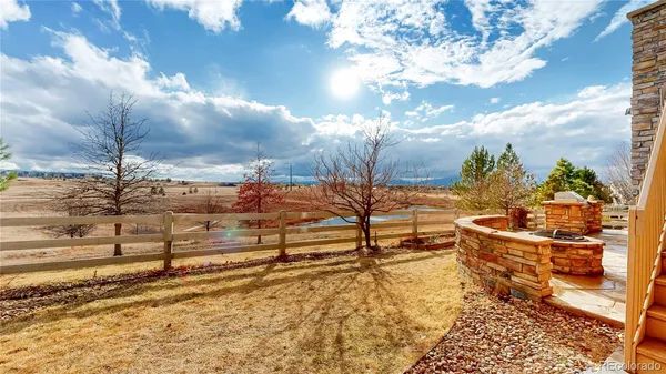 a view of a yard with wooden fence