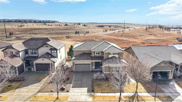 an aerial view of a house with a yard