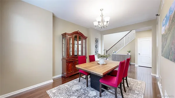 a living room with furniture wooden floor and a chandelier