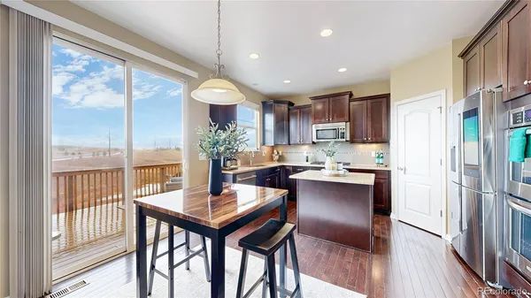 a kitchen with a table and chairs