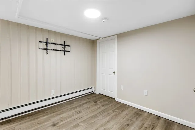 a view of a room with wooden floor
