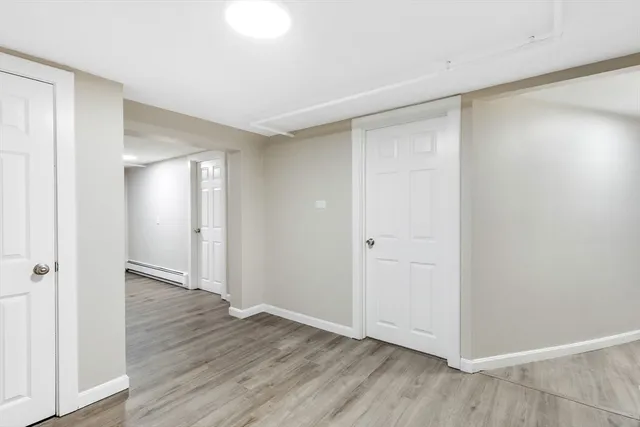 a view of an empty room with wooden floor