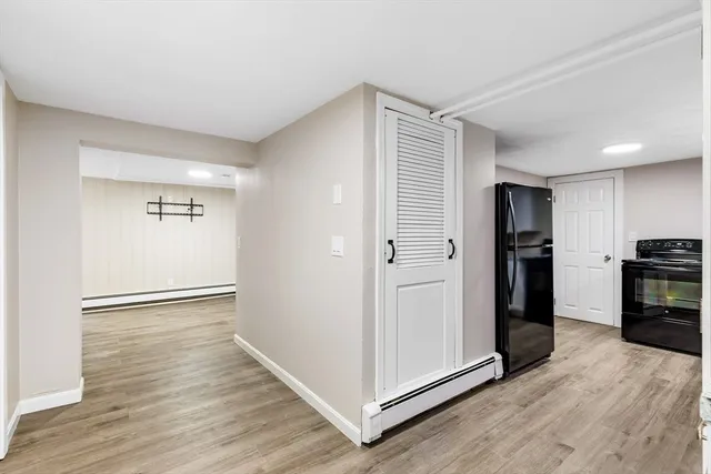 a view of a kitchen with refrigerator and an oven