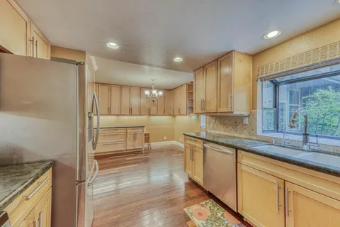 a kitchen with a sink cabinets and wooden floor