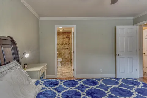 a bathroom with a granite countertop sink a toilet and a shower