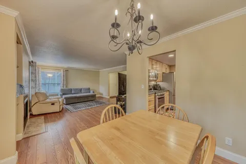a large kitchen with a large window and stainless steel appliances